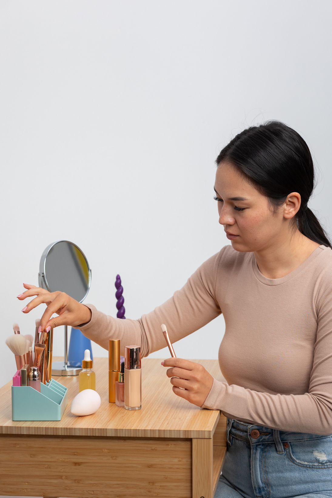 Woman Selecting Makeup Brushes