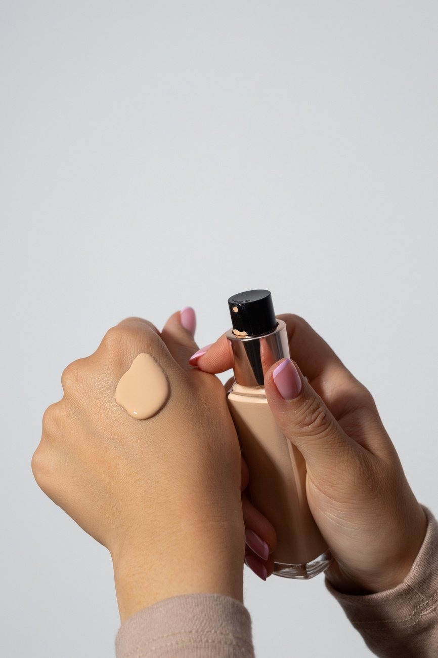 Person Applying Liquid Foundation on Hand