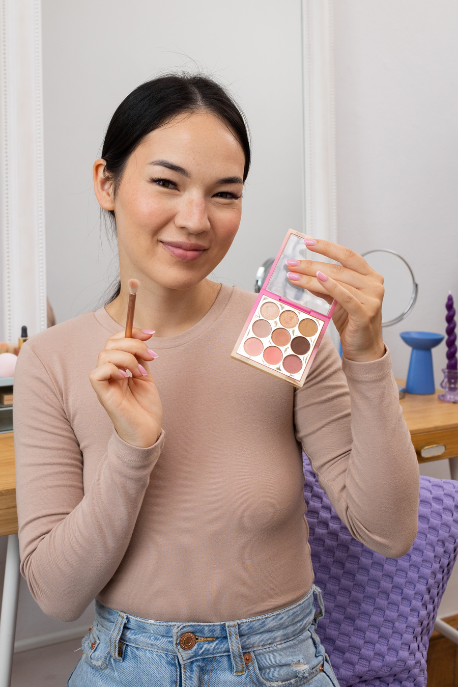 Woman Holding Makeup Palette and Brush