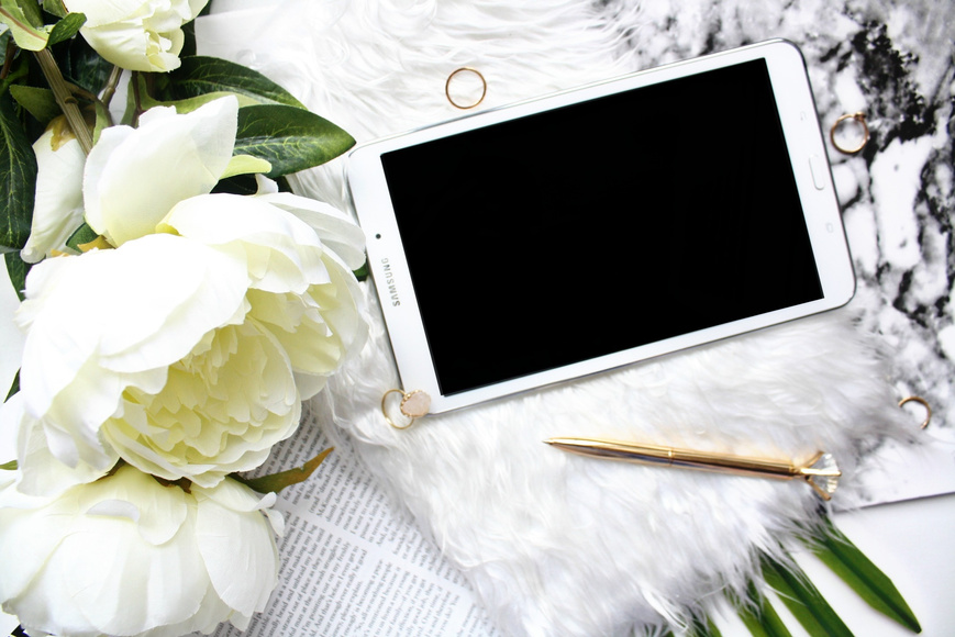 Top View of Tablet Device and Rose Flowers
